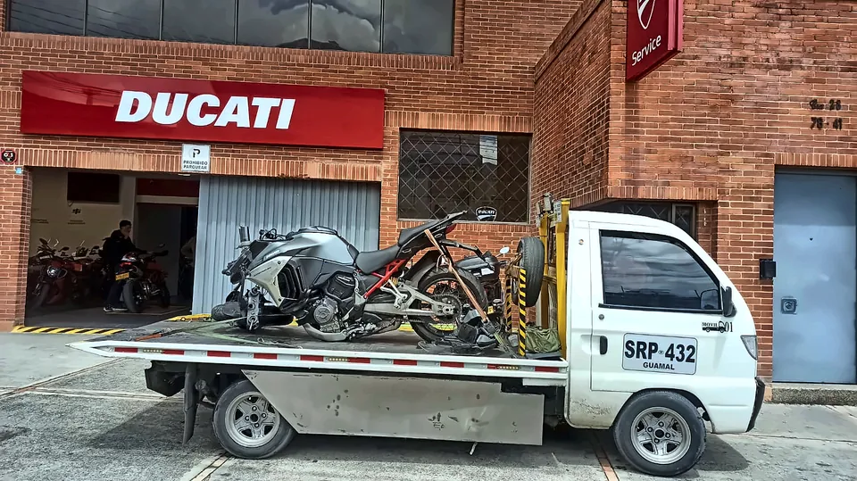 Moto en la grúa frente a un concesionario Ducati